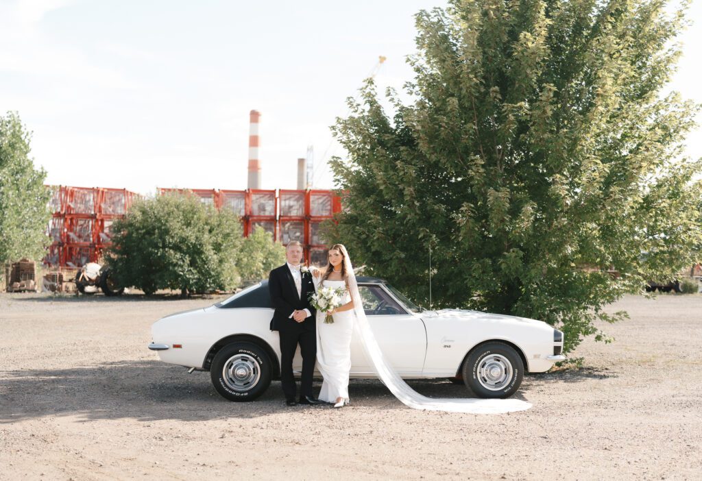Bride and Groom take couples portraits at Balstreri Vineyard with Vintage Classic car